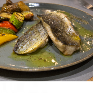 Grilled sea bass fillet with seasonal greens