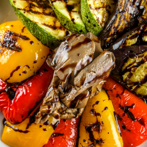 Grilled seasonal vegetables with balsamic cream sauce and thyme oil