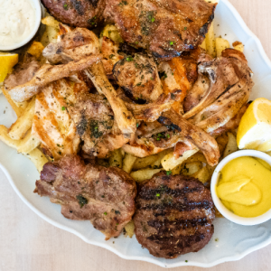 Meat platter for 2 people with chicken, lamp chops, beef burger patty, pork neck skewer, mykonian sausage and french fries French fries and