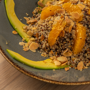 Quinoa with colorful peppers, avocado, fresh herbs and ginger-orange dressing