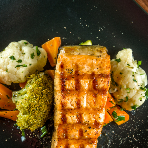 Roasted salmon fillet with seasonal greens