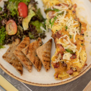 Omelet made with spinach, graviera cheese, smoked turkey and cherry tomatoes