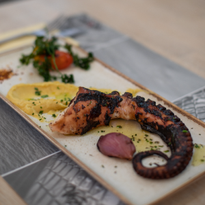 Grilled octopus with “fava” (split pea purée) and baked onions