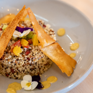 Quinoa with colorful peppers, avocado, fresh herbs and ginger-orange dressing