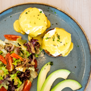 Benedict with poached egg, avocado, melted Cheddar cheese and hollandaise sauce